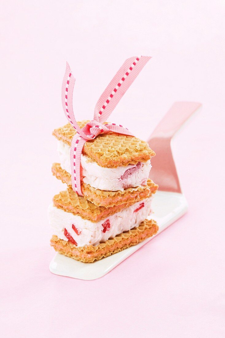 Ice cream sandwiches made with wafers and strawberry ice cream