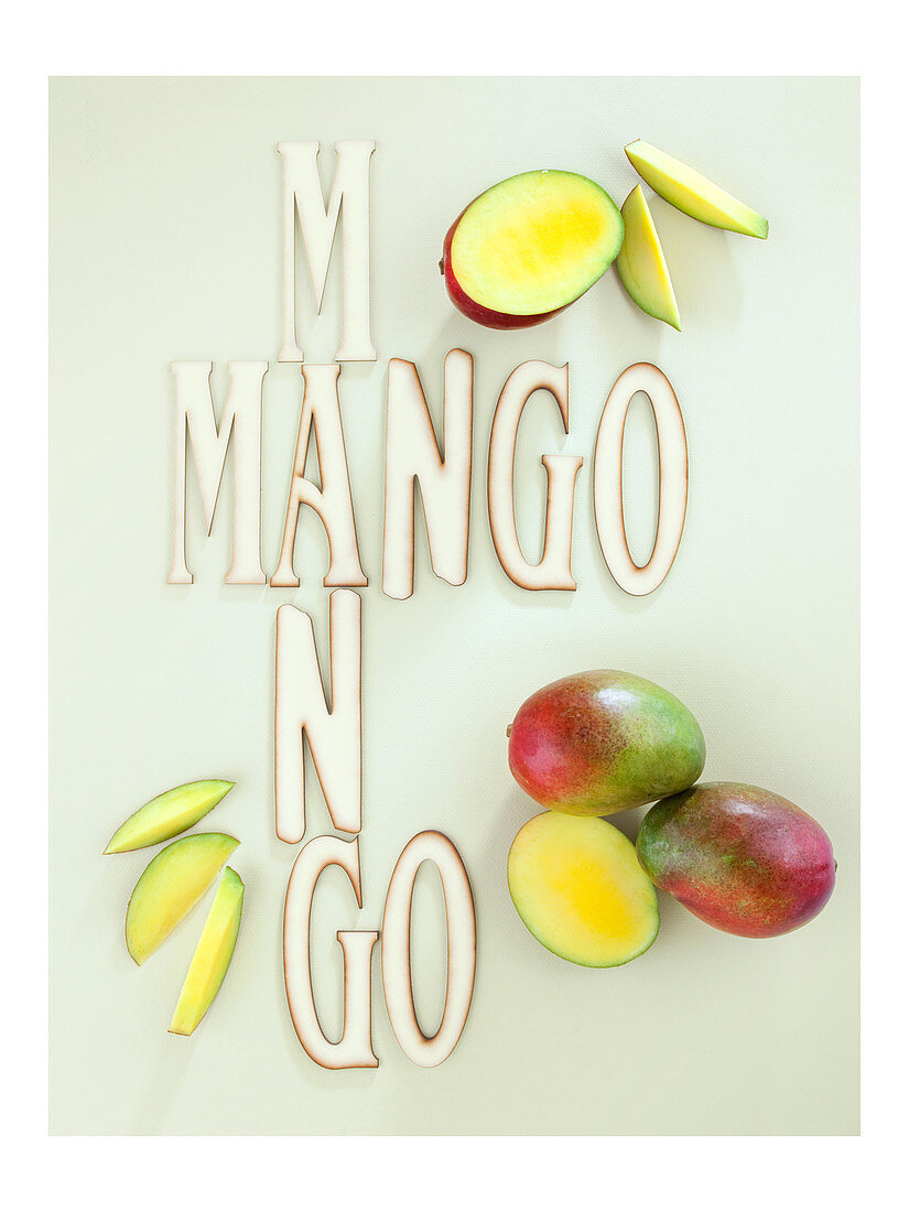 Fresh mangos next to lettering
