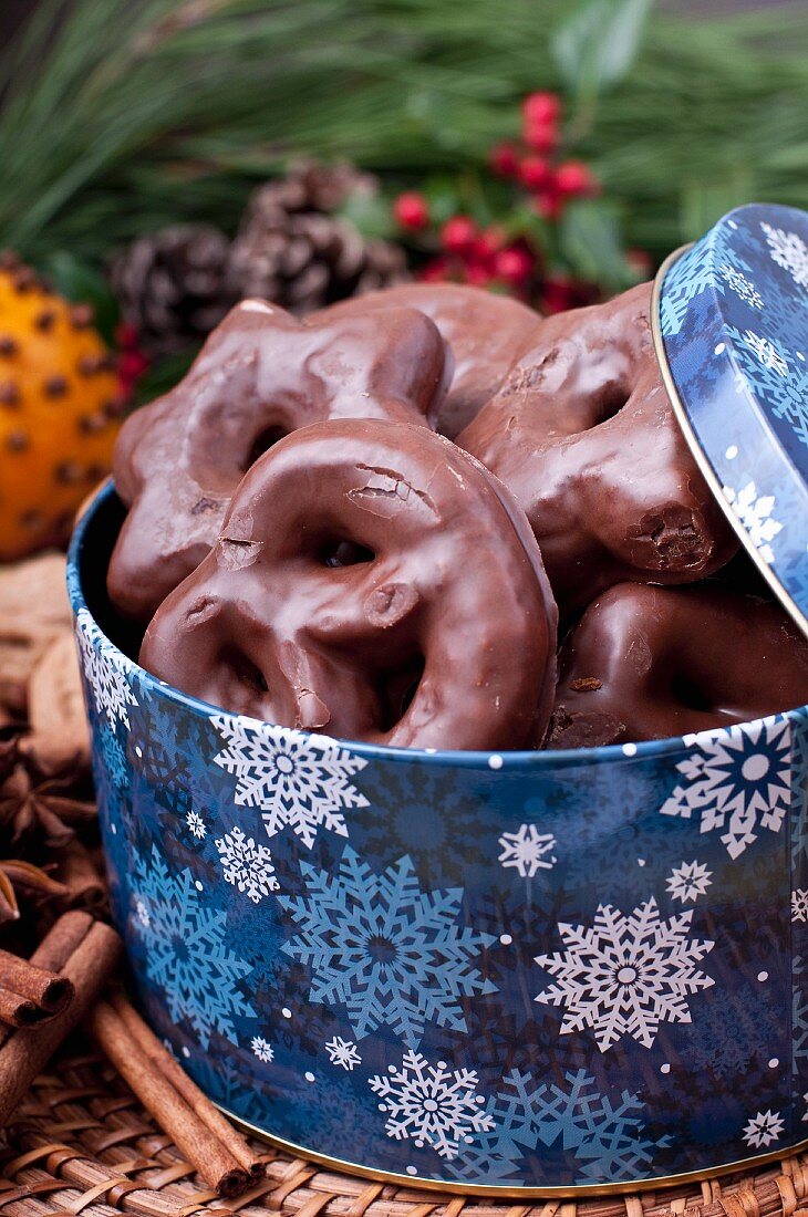 Chocolate coated gingerbread in a Christmas tin