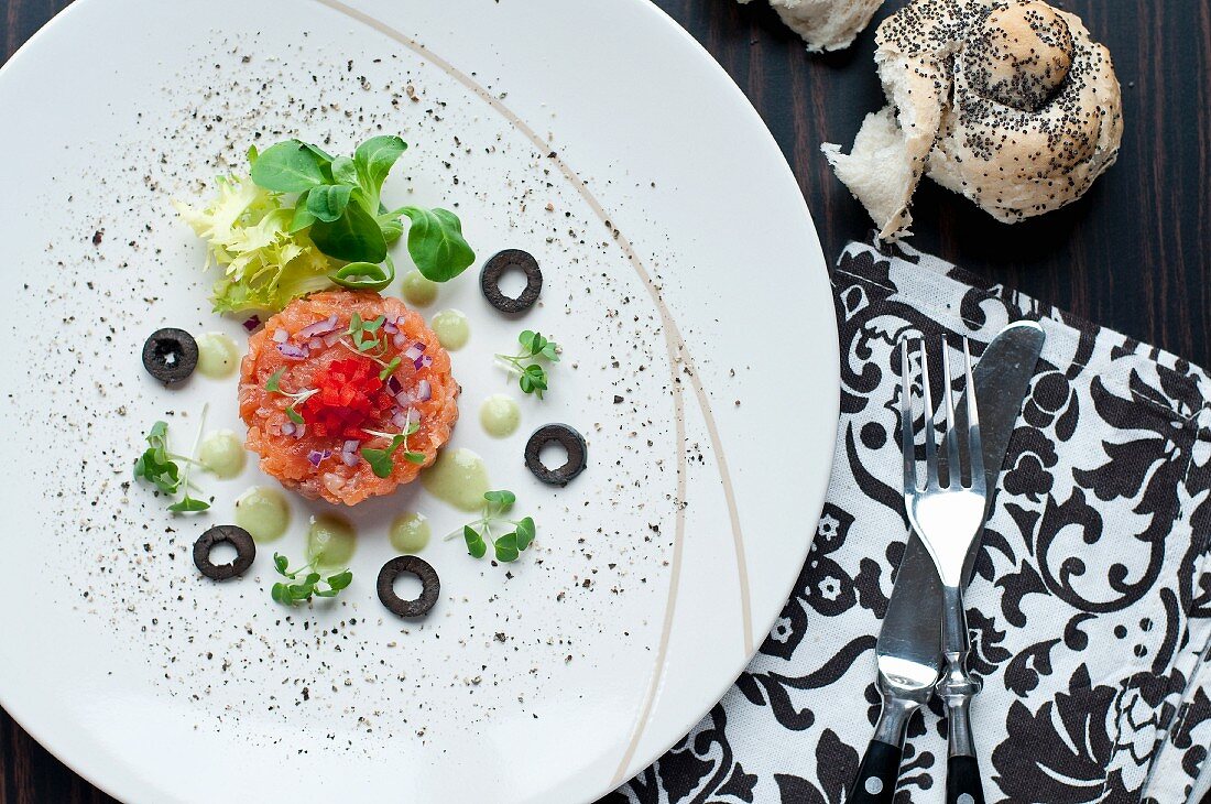 Smoked salmon tartar with cress, black olives and red pepper