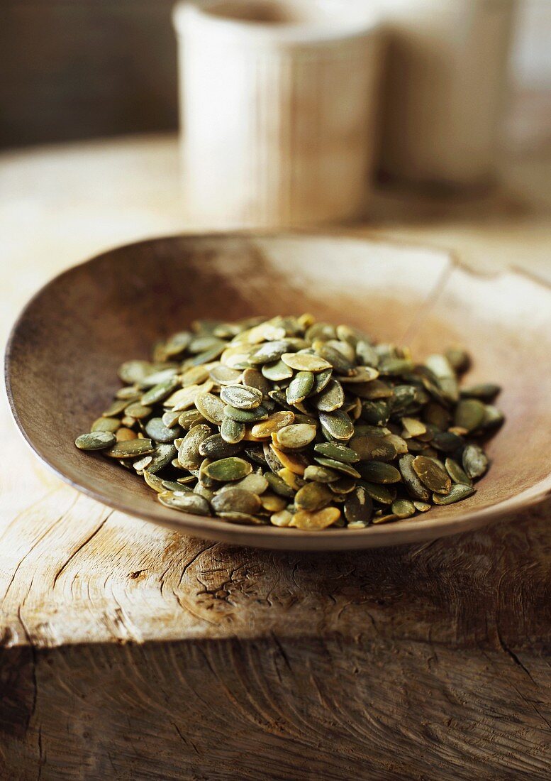 Wooden bowl of pumpkin seeds