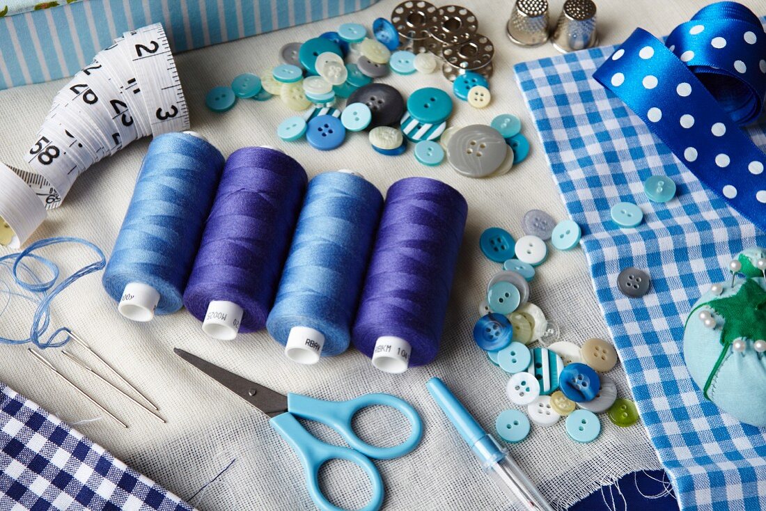 Thread, buttons, measuring tape on desk