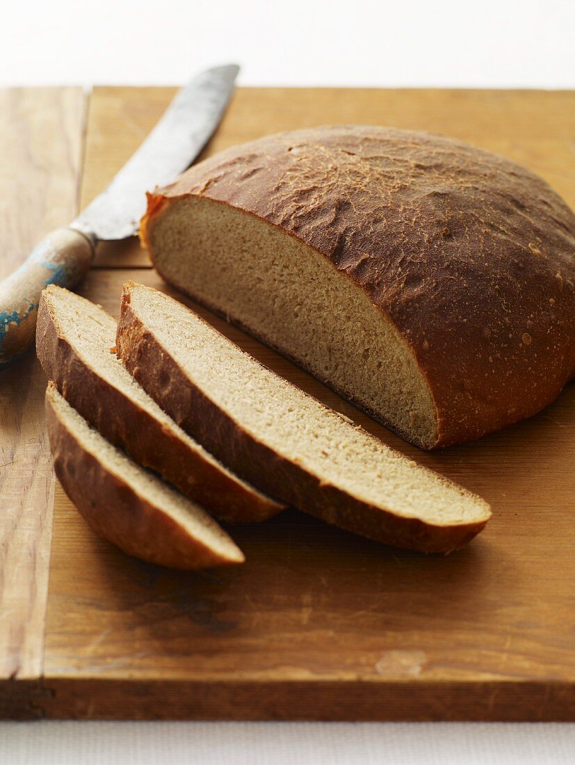 Homemade round Loaf of Bread; Partially Sliced