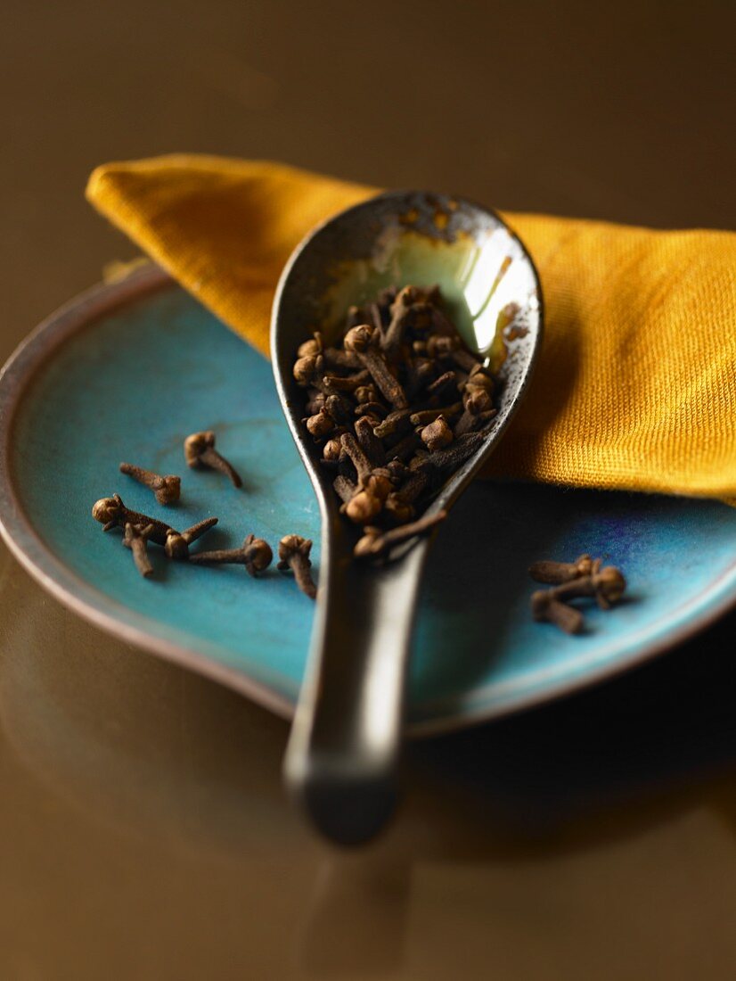 A Ceramic Spoon Full of Whole Cloves