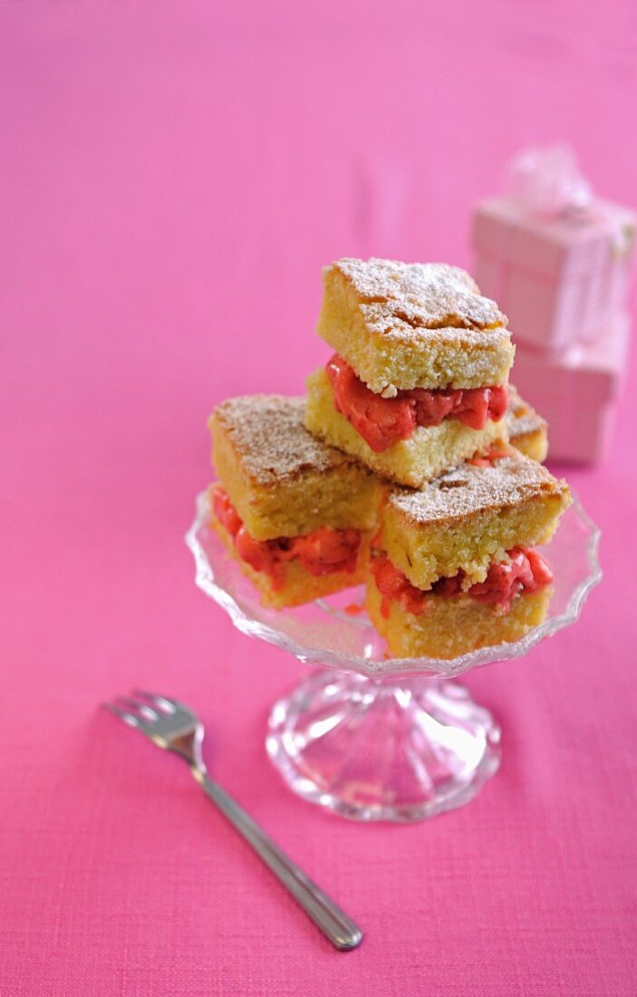 An ice cream sandwich made with lemon cake and strawberry ice cream