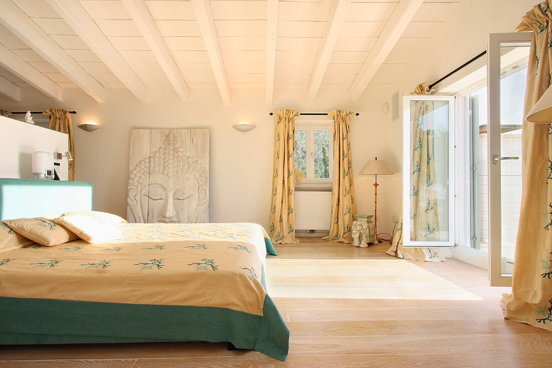 Master bedroom with French doors open to outdoor balcony