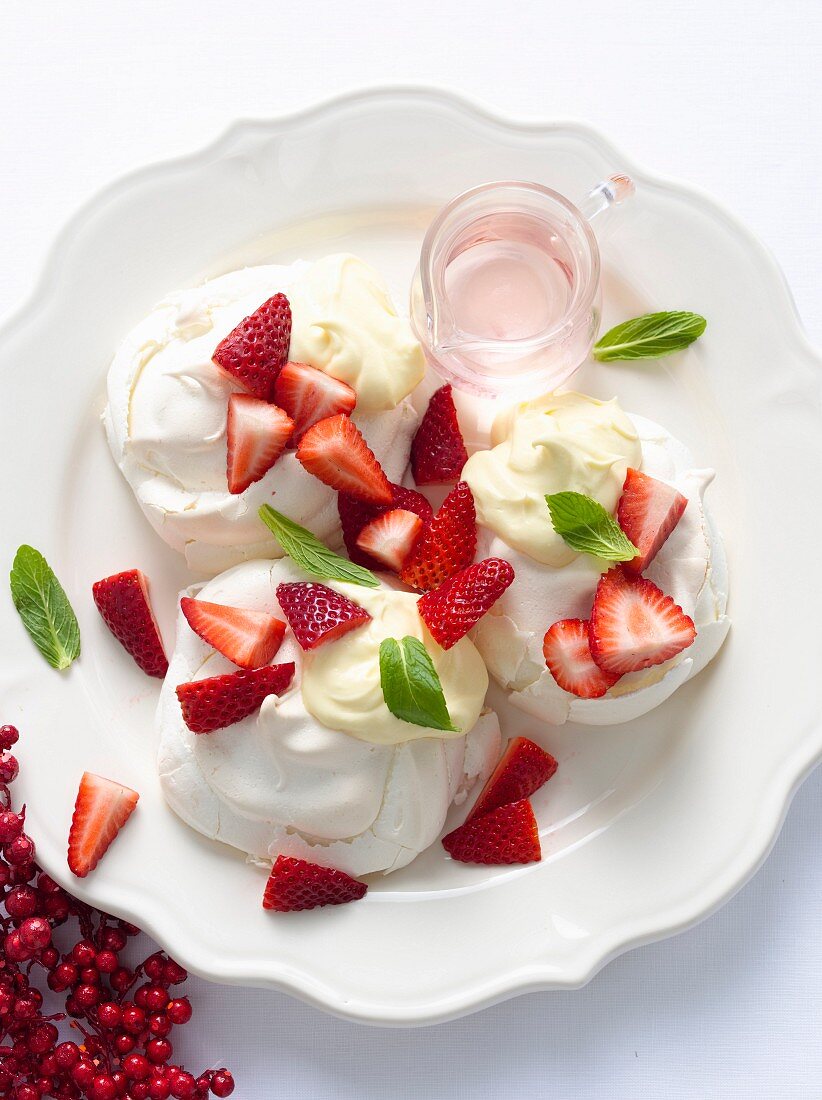 Plate of meringues with fruit and cream