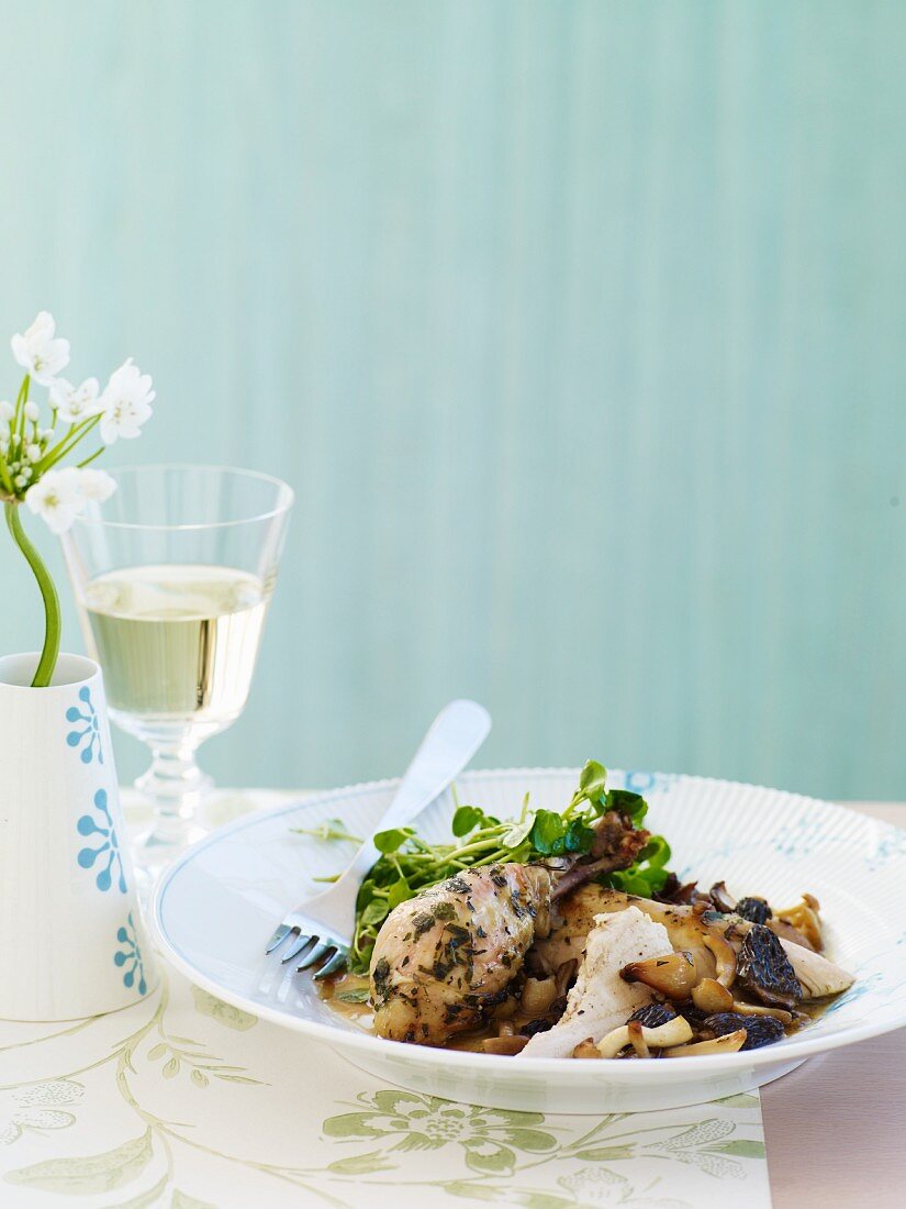 Chicken with Mushrooms Sauce in a Bowl; Glass of White Wine; Flowers
