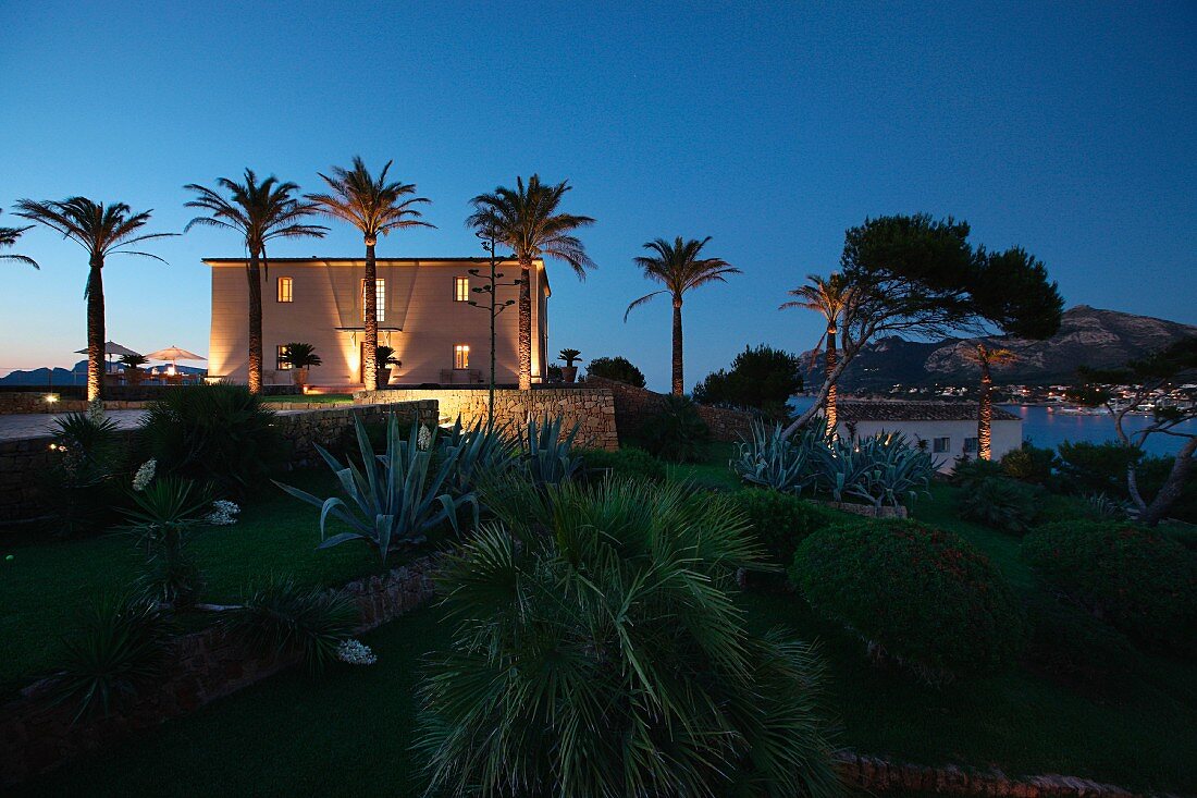 Front exterior Mediterranean style home at dusk