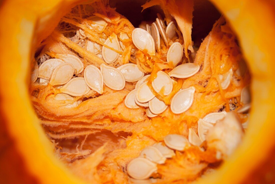 The Top of a Pumpkin Cut Off to Show the Seeds Inside