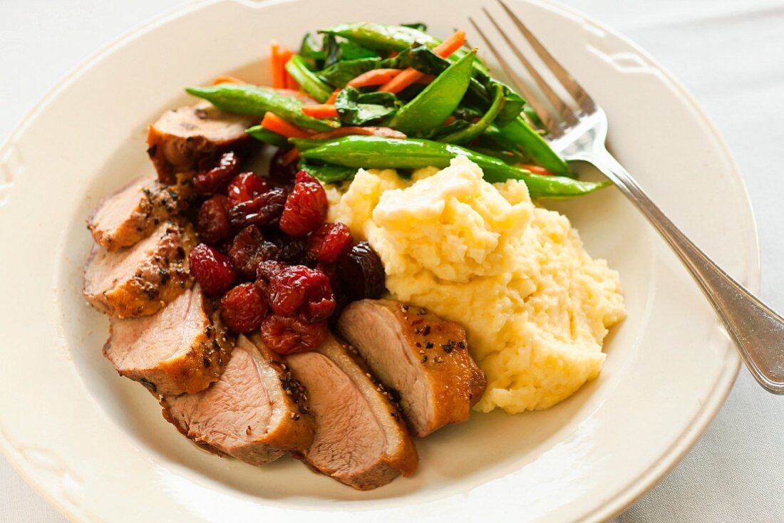 Sliced Duck Breast with Cherries, Mashed Potato and Mixed Vegetables