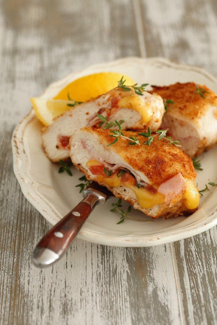 Stuffed chicken breast with ham, cheese, tomatoes and thyme