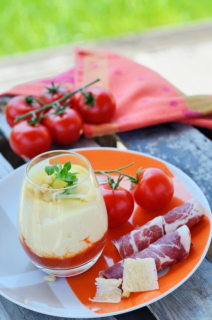 Layered tomato and Parmesan dish with coppa