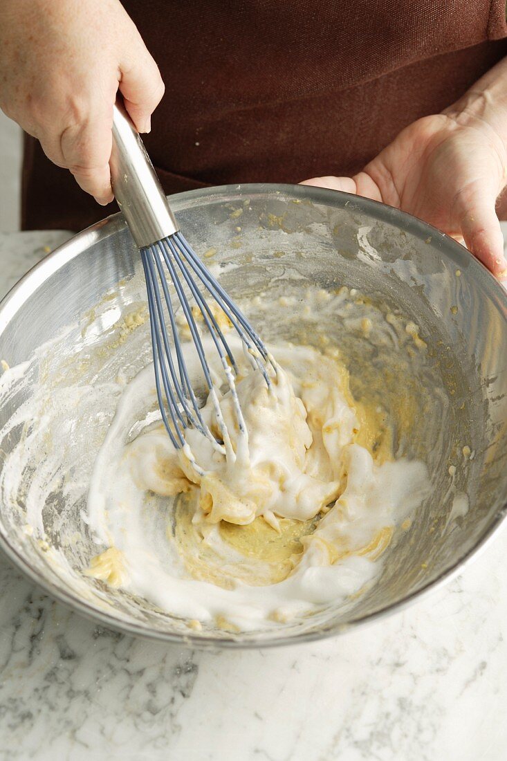 Chef whisking dough in bowl