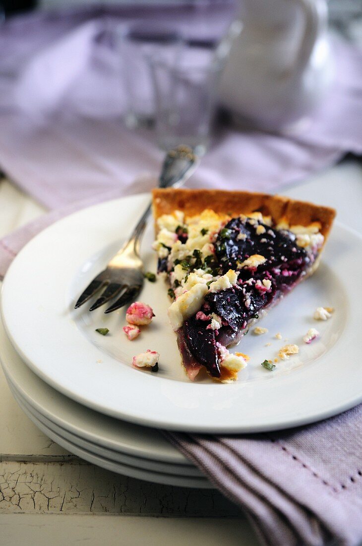 Slice of beetroot, goats cheese and red onion savoury tart