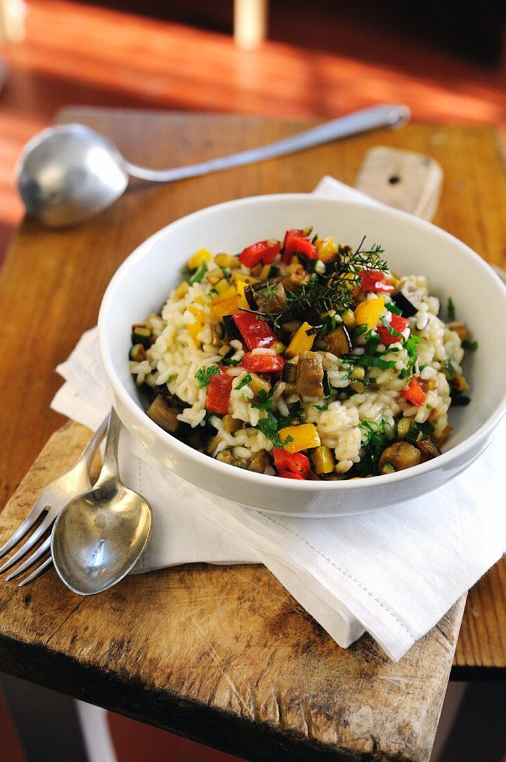 Mixed vegetable risotto with sweet bell peppers, aubergines, courgettes and flavoured with parsley and thyme