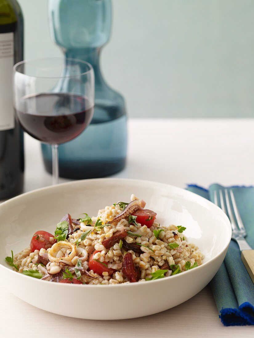 Calamari and Barley Salad in a White Bowl with Red Wine