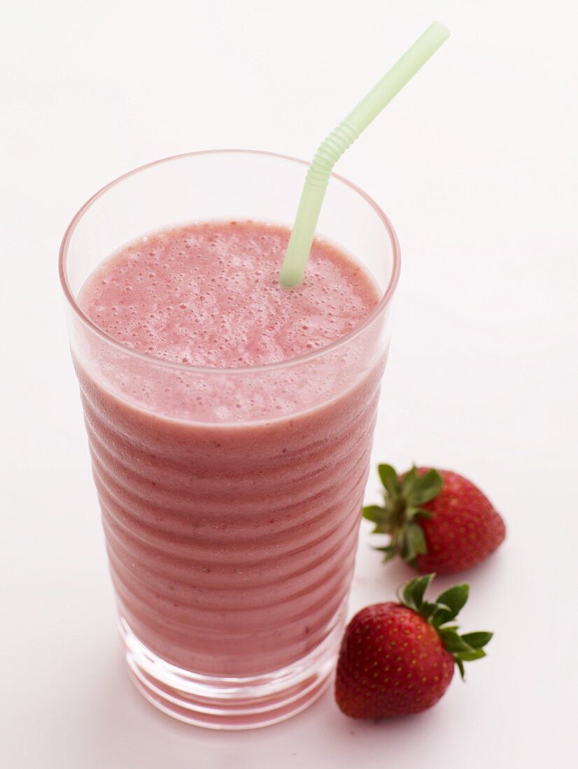 Strawberry Smoothie in a Glass with a Straw; Fresh Strawberries