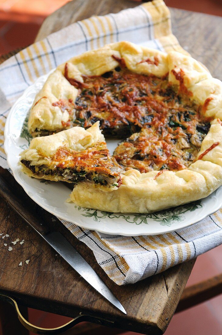 Swiss chard and ricotta puff pastry savoury tart topped with parmesan cheese