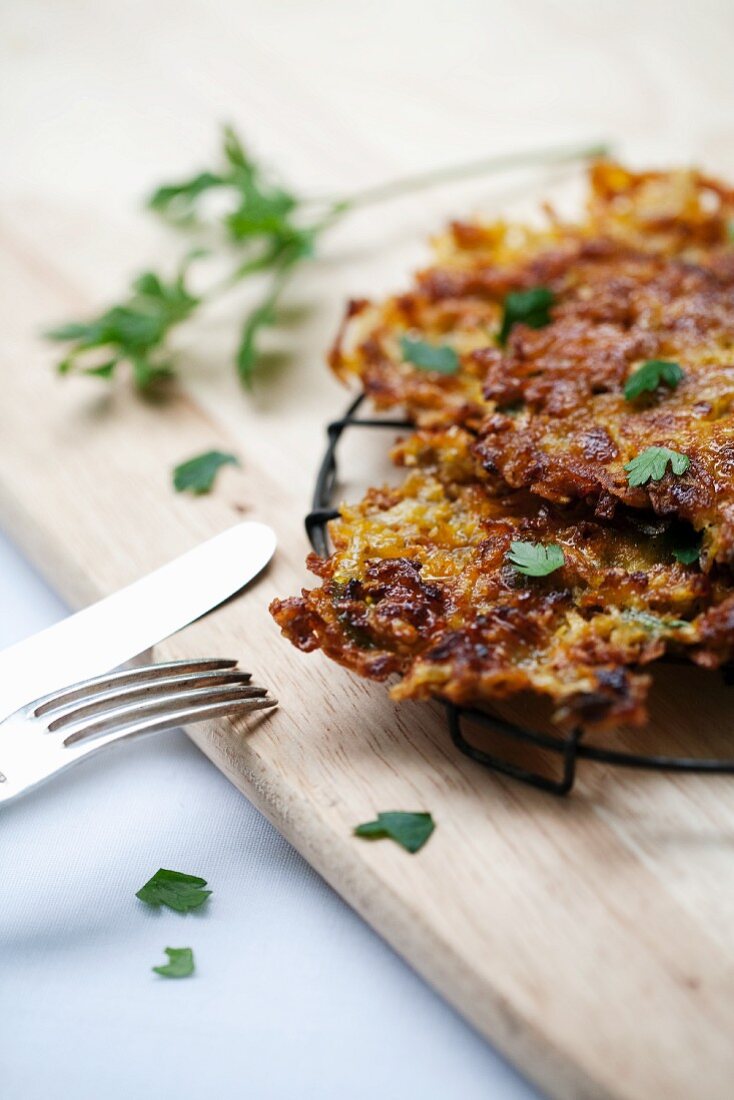 Potato Pancakes on a Cooling Rack on a Cutting Board