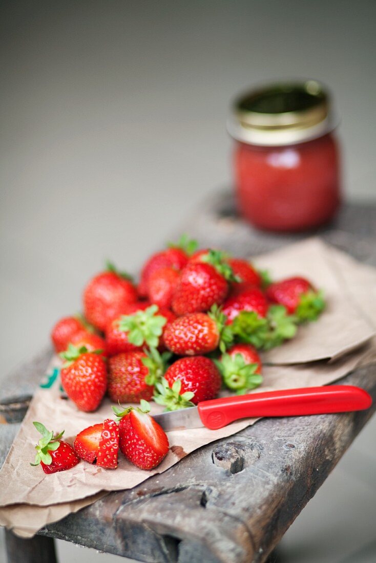 Fresh Strawberries on a Paper Bag; Knife; Jam