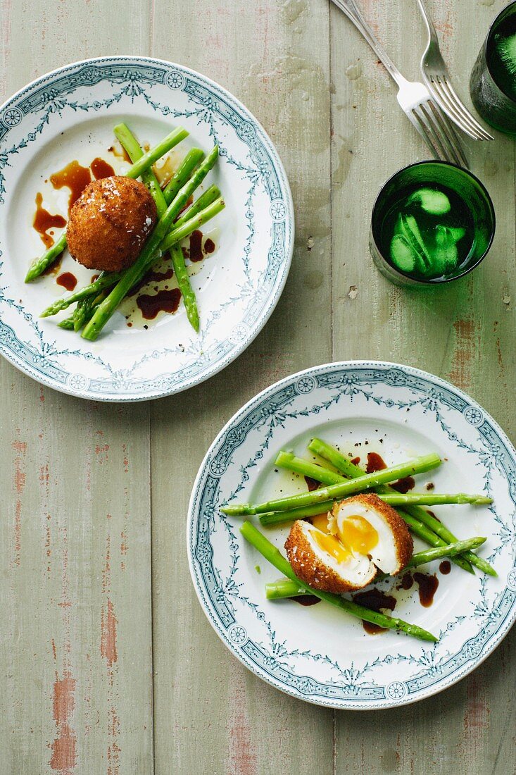 Plates of fried eggs and asparagus