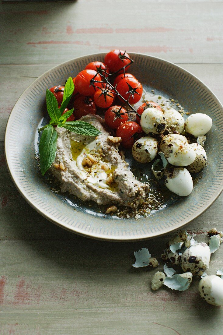 Plate of quail eggs dukkah with tomatoes