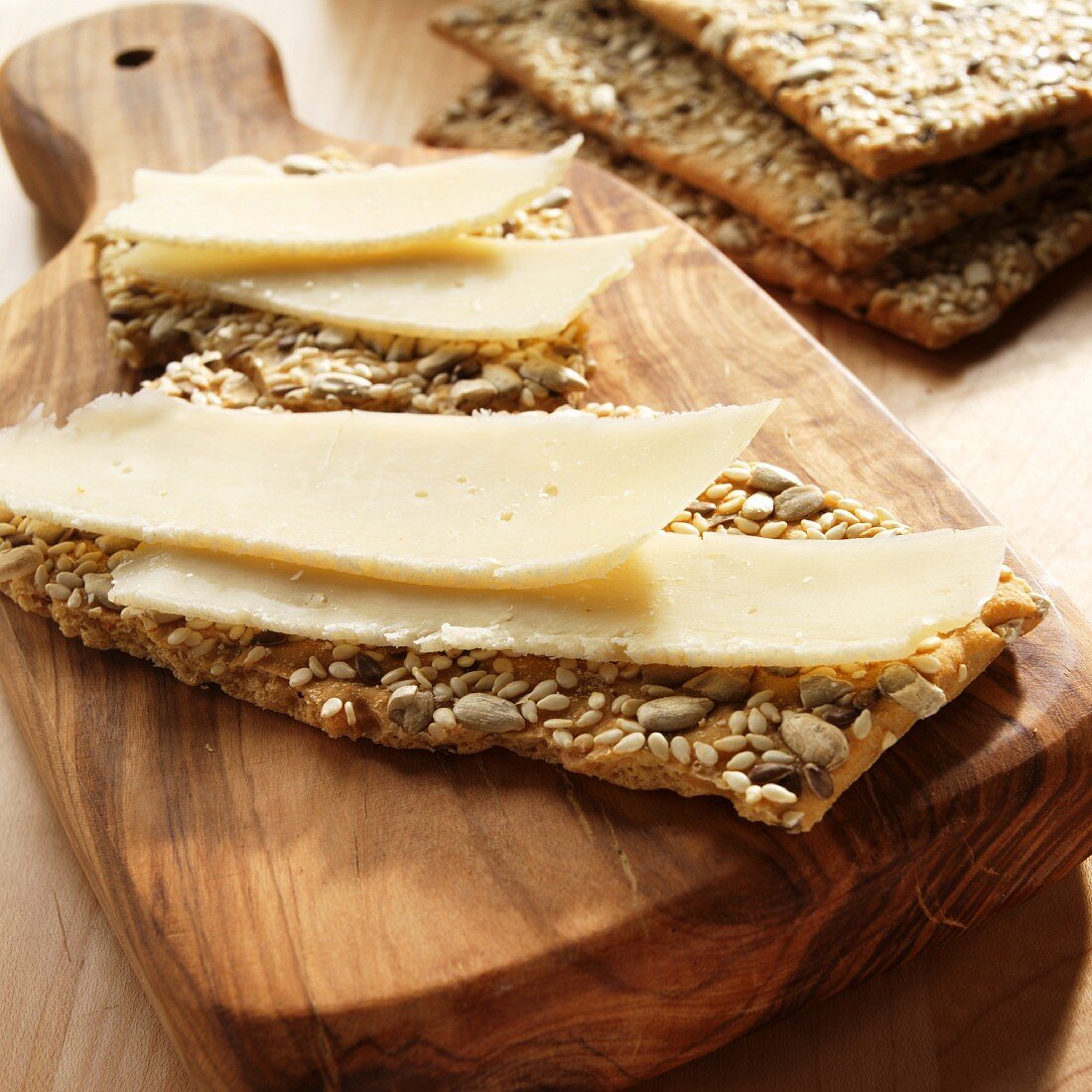 Slices of Asiago Cheese on Multi-Seed Crackers