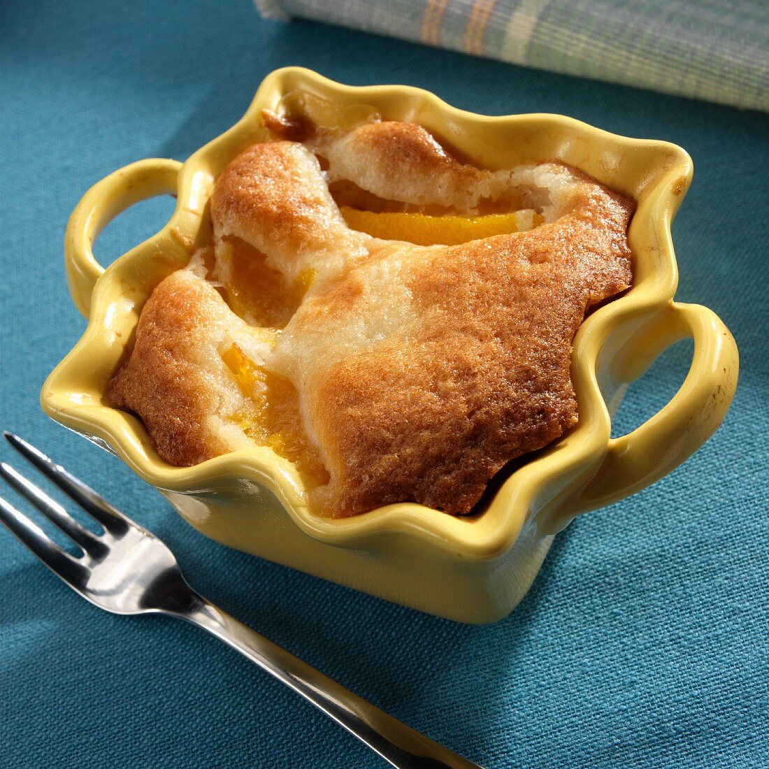 Individual Peach Cobbler in a Yellow Baking Dish