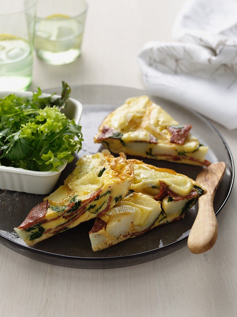 Plate of quiche with green salad