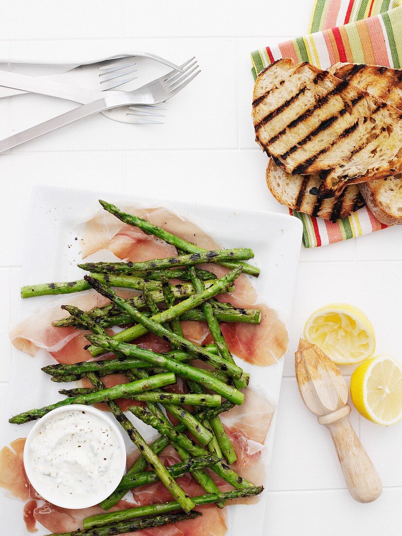 Plates of ham, asparagus, and bread