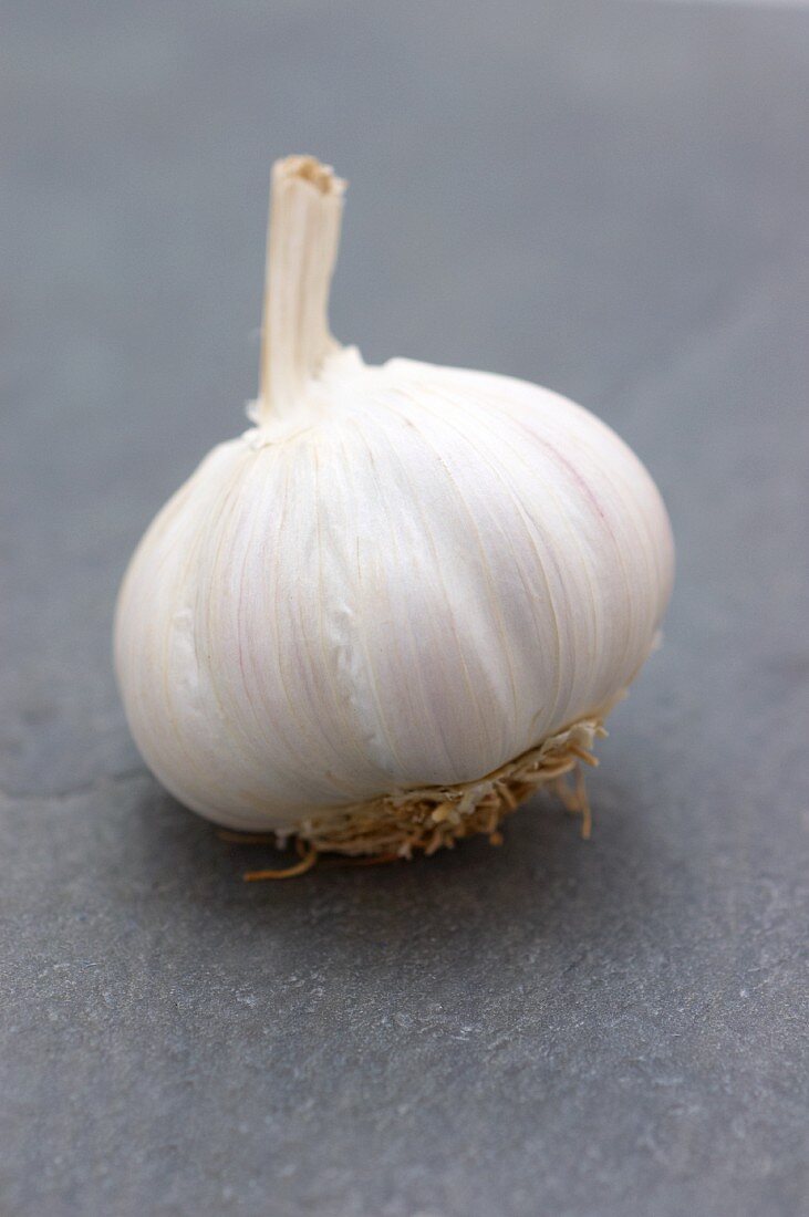 A garlic bulb on a slate surface