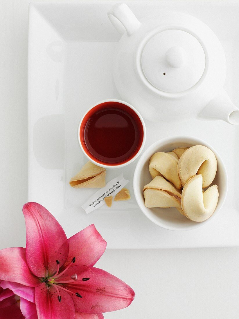 Tray of fortune cookies, sauce and tea