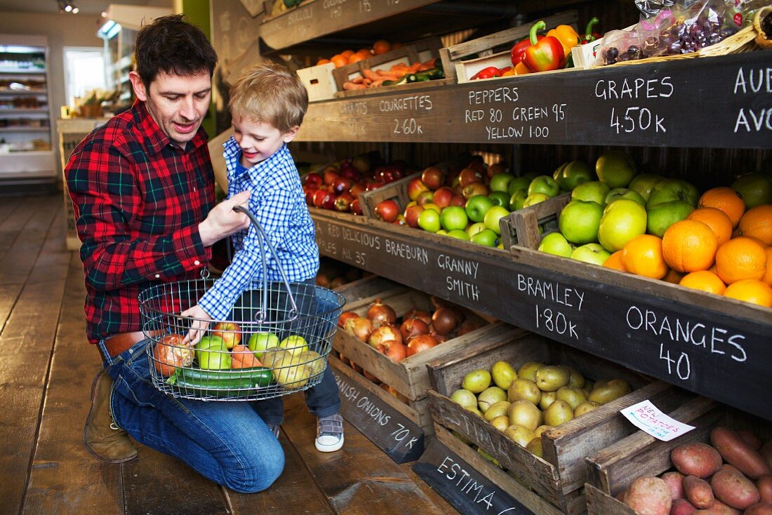 Father and son buying produce in store