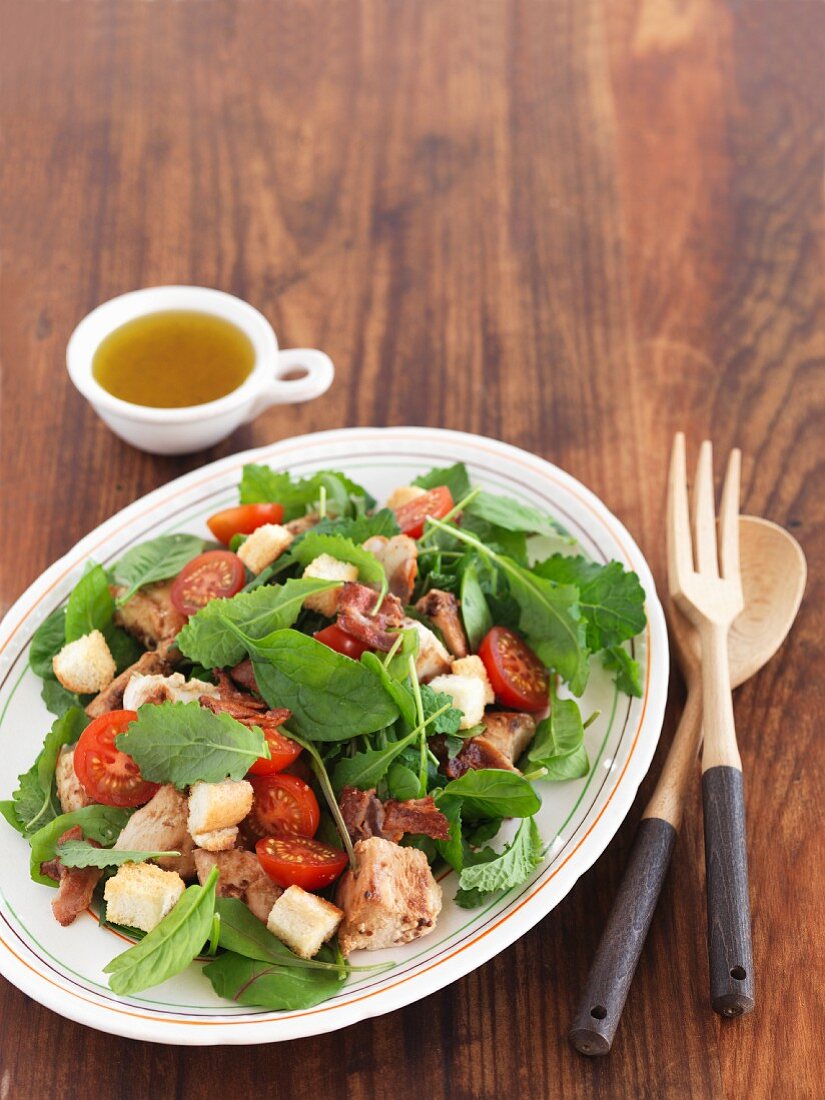 Spinach salad with chicken, bacon and a honey and citrus dressing