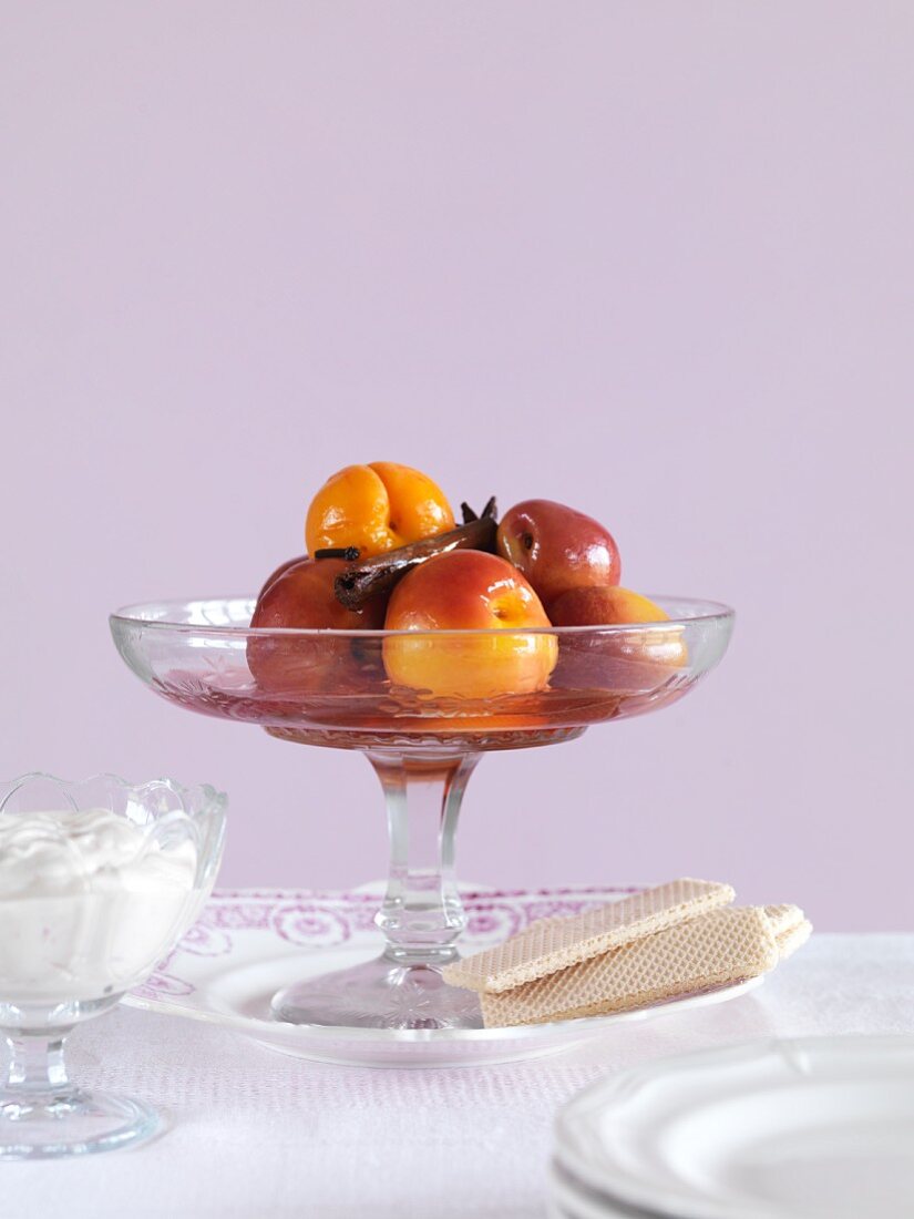 Poached stone fruits in a glass bowl