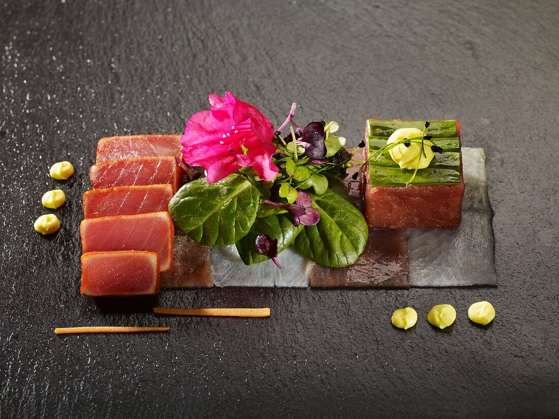 Tuna tataki and tartar arrange on slices of sea bass and tuna