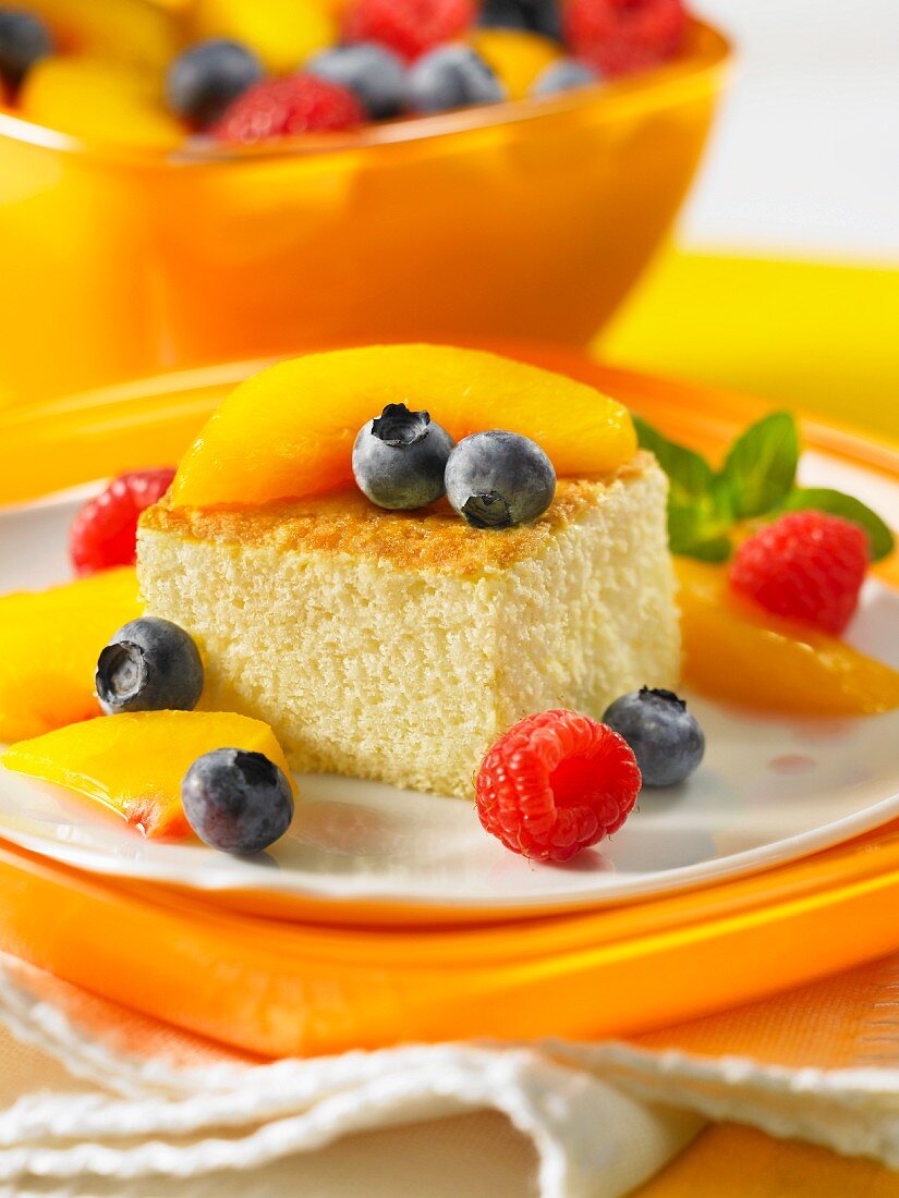 A slice of sponge cake garnished with fresh fruit
