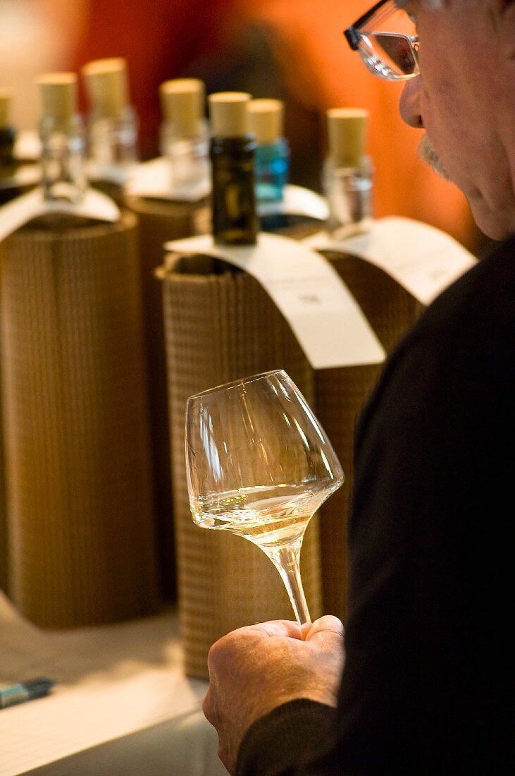 Blind wine tasting: A man tasting white wine