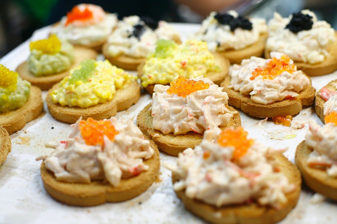 Small Slices of Toasted Bread Topped with Crab Salad and Egg Salad