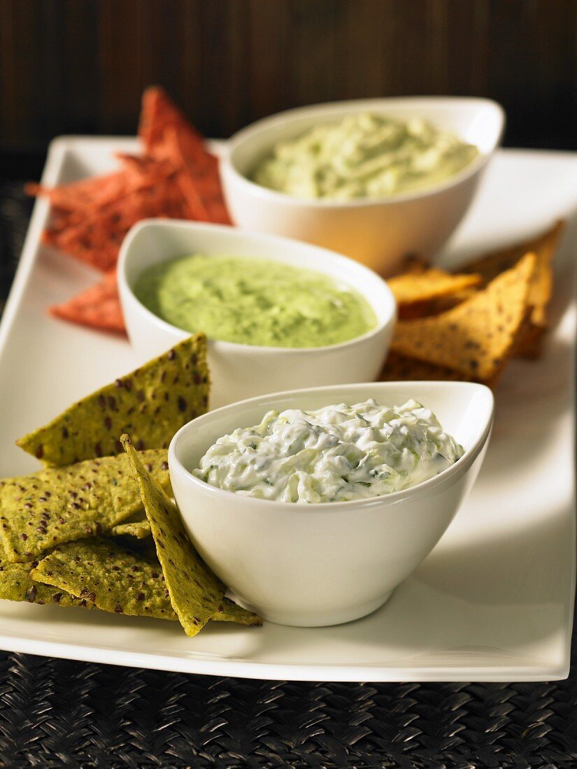 Tortilla chips with three different dips