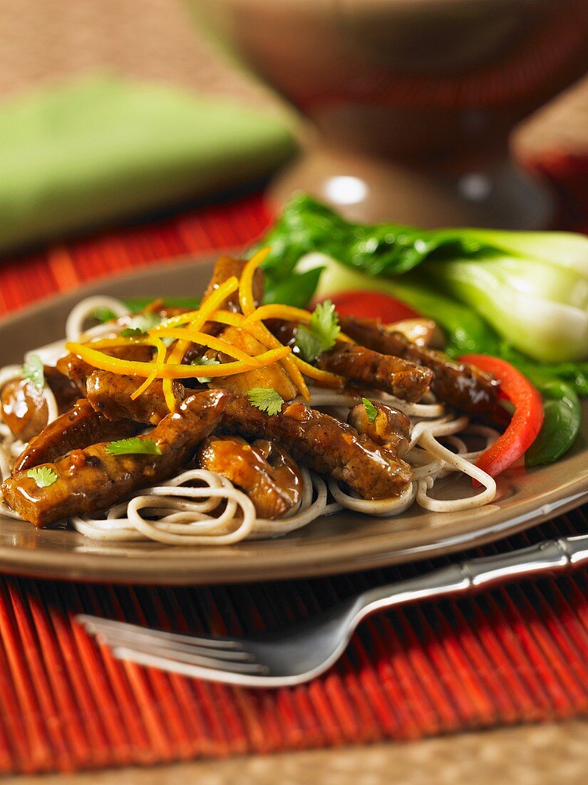Stir-fried beef with orange and ginger sauce with oriental noodles
