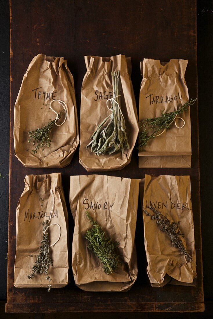 Six Dried Herbs on Brown Paper Bags with Labels