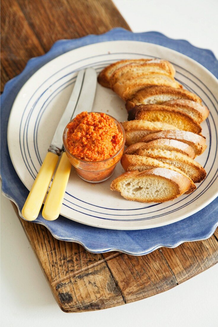 Toasted baguette slices with rouille (puréed pepper spread)