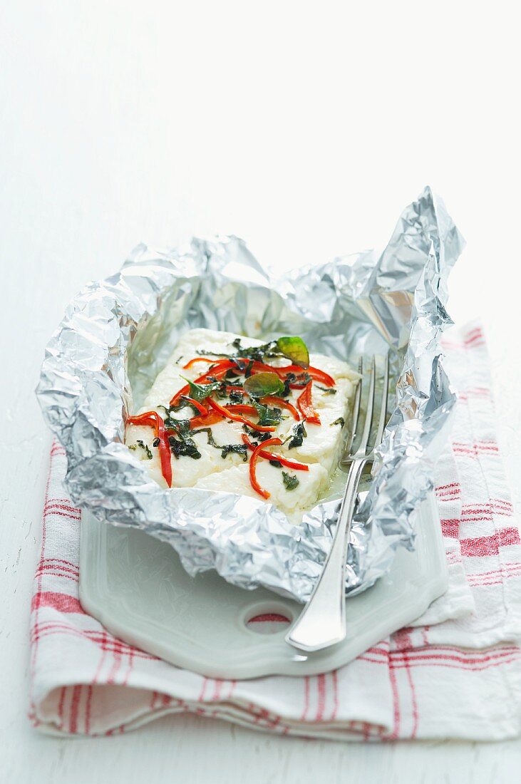Grilled cheep's cheese with chilli and oregano in tin foil