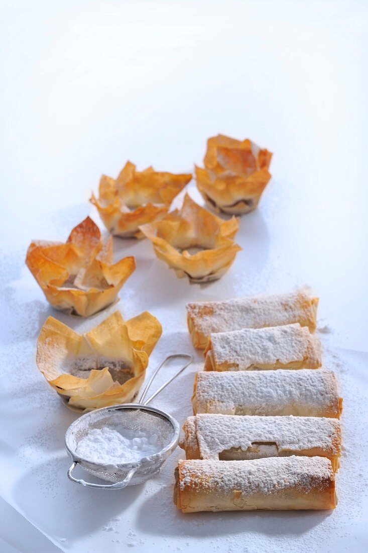 Puff pastry rolls and puff pastry bowls with icing sugar