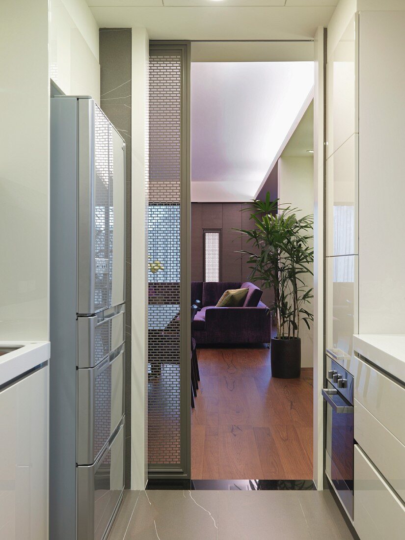 View through modern kitchen to living room