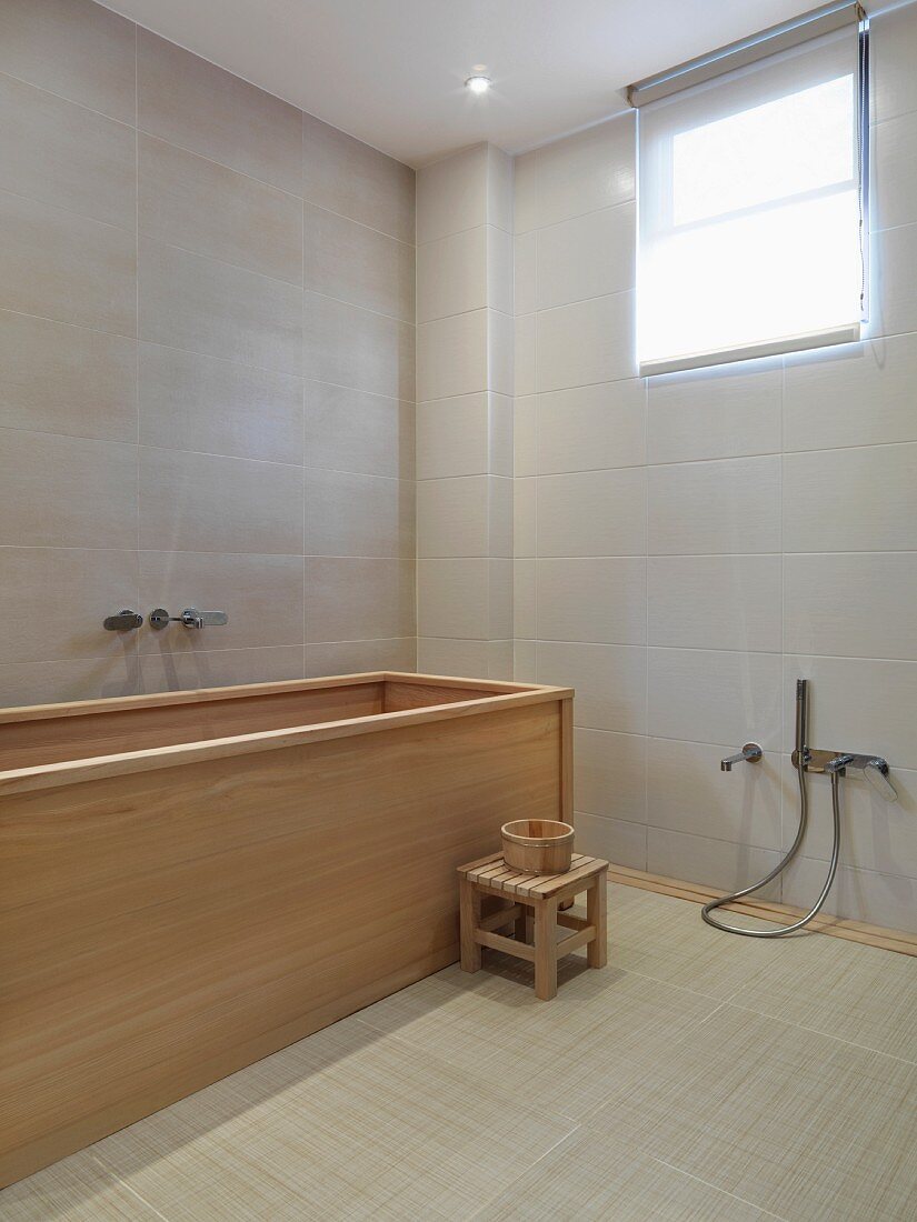 Modern bathroom with wooden bathtub