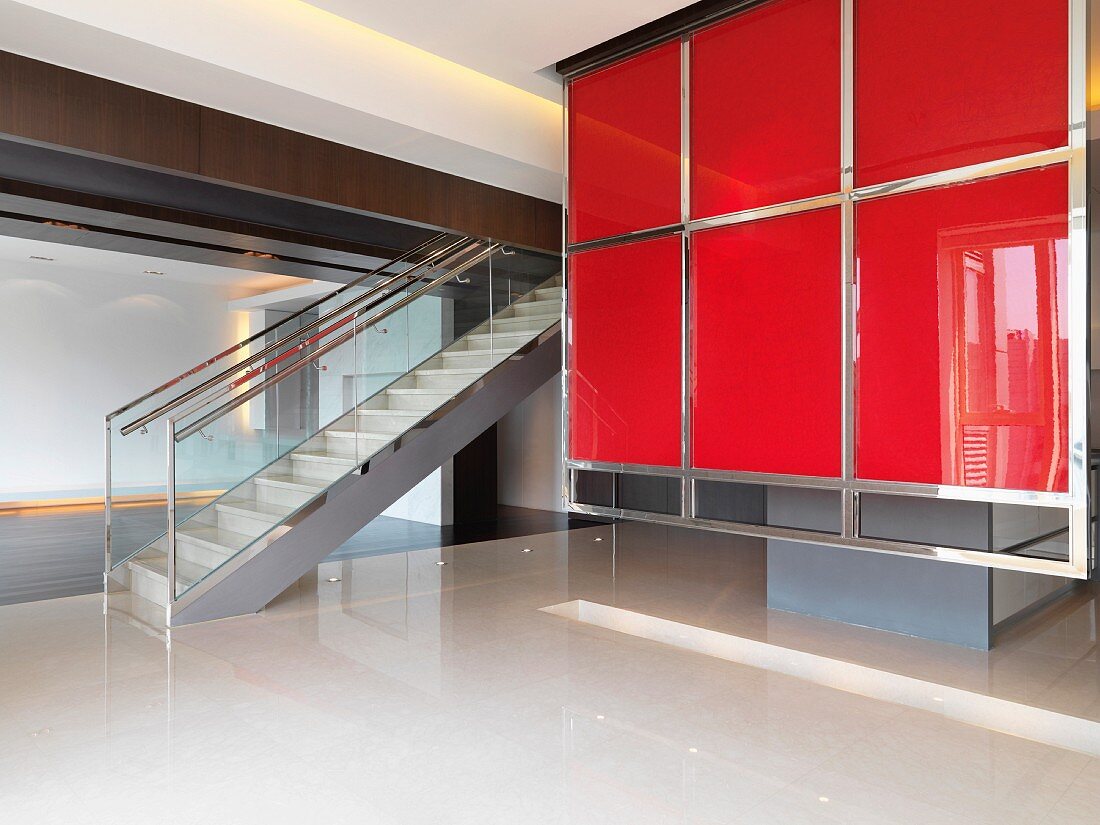 Staircase and red wall in unoccupied modern home