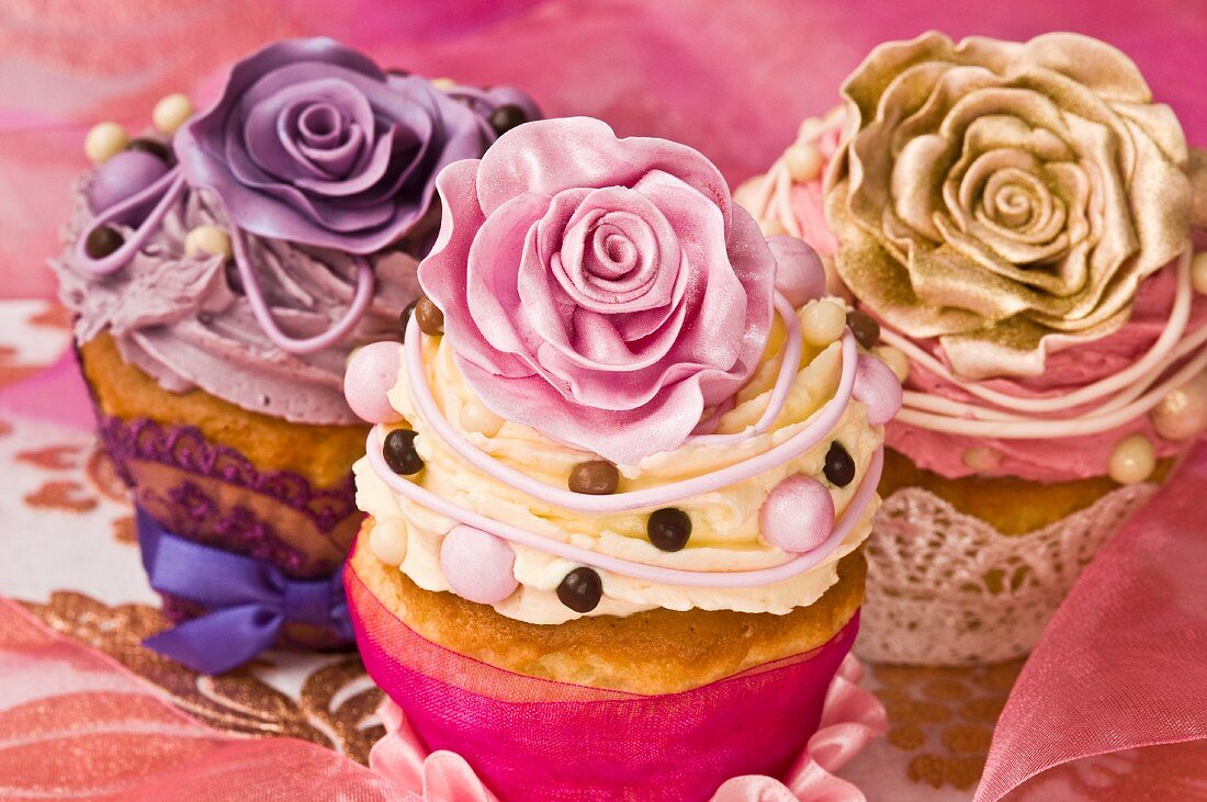 Celebratory cupcakes decorated with buttercream and sugar roses